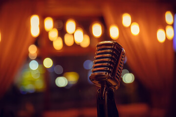 Metal microphone on blurred background close-up - 549849955