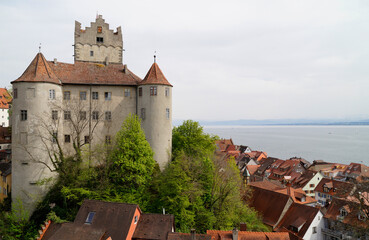 Northwest side of the beautiful medieval Meersburg castle or Burg Meersburg, Lake Constance (Bodensee) is in the background on a gloomy overcast spring day (Germany)