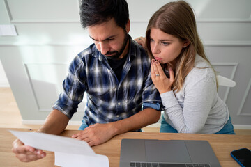 Young Caucasian man feeling stressing about over unpaid bills. People, first home, mortgage and debts concept