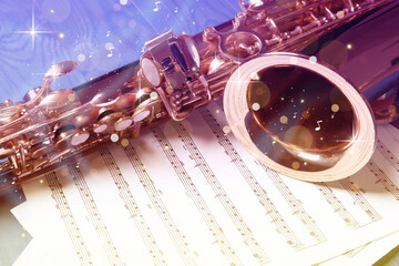 Beautiful saxophone and note sheets on table, closeup