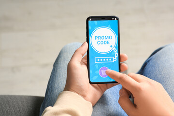 Man activating promo code on smartphone, closeup