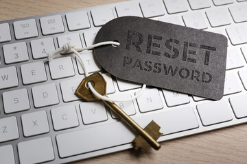 Key with tag RESET PASSWORD on keyboard, closeup