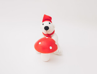 Polar bear with huge red mushroom na beloj pozadini.
