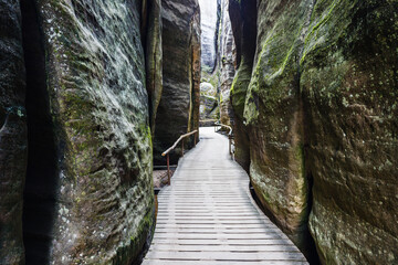 Narrow hiking path between sandstone rock walls