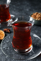 Glasses of traditional Turkish tea on grey textured table, closeup