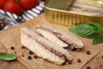 Canned mackerel fillets served on wooden board, closeup