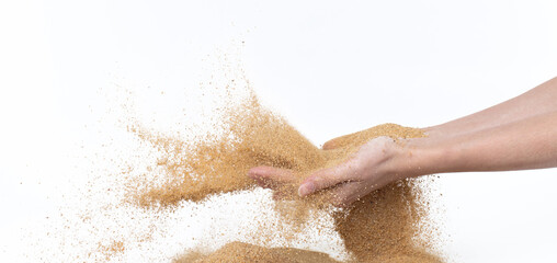 Fototapeta premium Sand flying explosion, Golden sand wave explode. Abstract sands cloud fly. Yellow colored sand splash throwing in Air. White background Isolated high speed shutter, throwing freeze stop motion