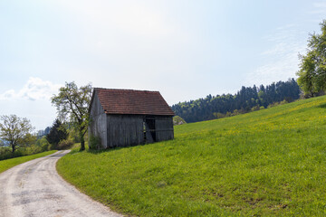 Naklejka na ściany i meble Gravel road to an old wooden Barn in Germany