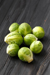 Brussels sprouts on a dark wooden background.