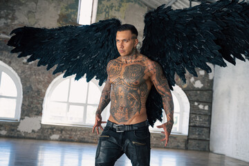  angel man with black wings, stand posing at camera. man fall from heaven, angel with muscular body...