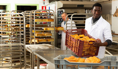 Portrait of successful baker during daily work in bakeshop. High quality photo