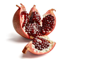 Beautifully cut and broken ripe pomegranate isolated on white background