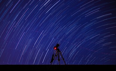 Telescope with a blurred starry night sky view in a planetarium