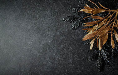 Christmas background with black and golden decorative twigs. Copy space