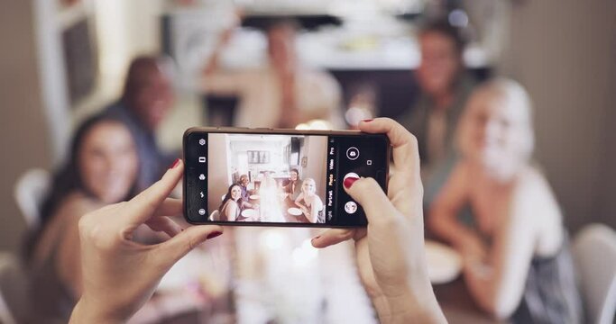 Phone photo, dinner and friends at a celebration, party or house event together. Social, smile and hands of a person with a mobile picture of people at a dining room table for lunch in a home