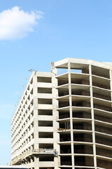 Construction site with unfinished building on sunny day