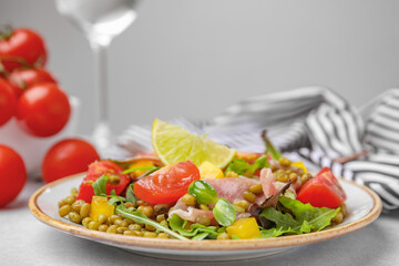 Plate of salad with mung beans on white table