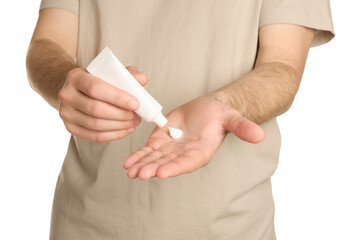 Man applying cream onto hand against white background, closeup