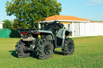 Modern quad bike near house on sunny day, space for text