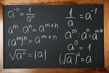 Many different math formulas written on chalkboard, closeup