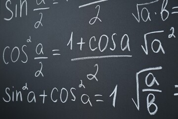 Fototapeta na wymiar Different mathematical formulas written with chalk on blackboard, closeup