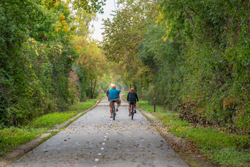 Obraz premium Bicycle Riders On The Local Trail In Fall