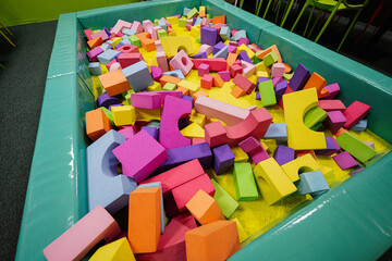 Pool with different geometric shapes at indoor play center playground.
