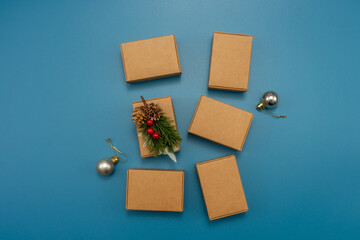 Gift boxes and Christmas decorations on blue background, flat lay.