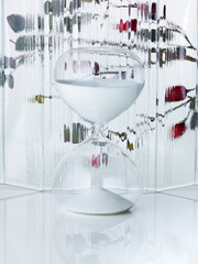 Hourglass on transparent glass background