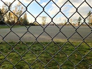 Close up of mesh fence in elementary school area, concept of safety
