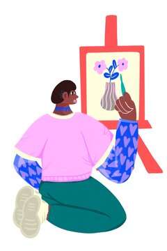 Woman painting a canvas in profile while kneeling