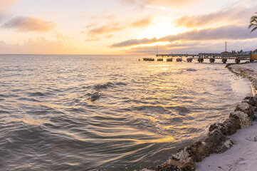 Naklejka premium Sunset on Hurricane Damaged Pier on Casa Marina Beach, Key West Florida, USA