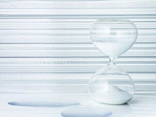 Hourglass on transparent glass background