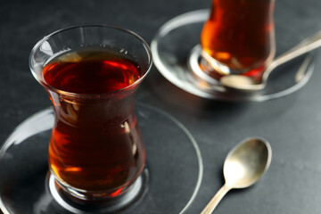 Glasses with traditional Turkish tea on black table, closeup