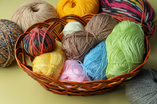 Many different soft woolen yarns on yellow background