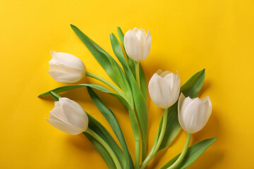 Many beautiful tulips on yellow background, flat lay