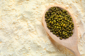 Mung bean flour and spoon with seeds, closeup