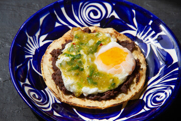 Mexican green ranchero eggs on tortilla toast.