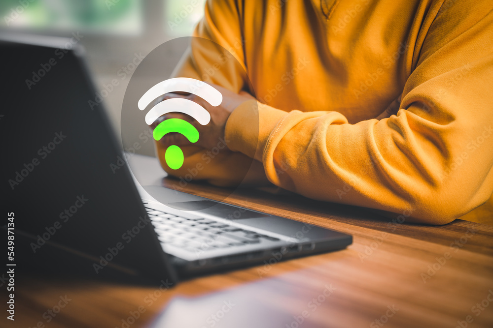 Fototapete Man using a computer laptop to connect to wifi but wifi signal is very weak, and waiting to loading digital business data form website, concept technology of waiting for connect to wifi.