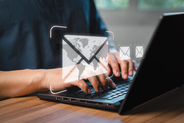 Fototapeta premium Man's hand using computer laptop and sending online message with email icon, email marketing concept, send email or newsletter, internet network working online.
