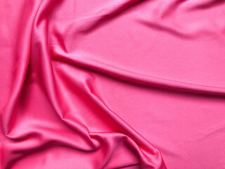 Soft silk textile texture for background. Abstract pink fabric for poster, banner, wallpaper and creative project.