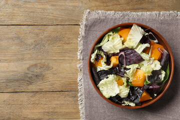 Delicious salad with Chinese cabbage, tomato and basil on wooden table, top view. Space for text