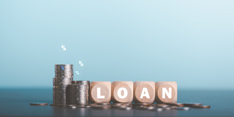 Stacks of coins and wooden blocks on table,investment loan concepts to build a residential...