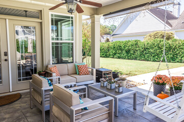Covered outdoor patio in a new construction house home with guest seating - obrazy, fototapety, plakaty