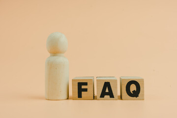 Wooden blocks with the word FAQ, acronym frequently asked questions. Collection of frequently asked...