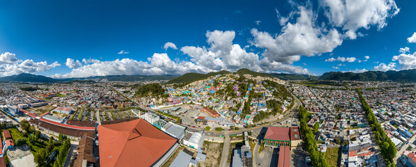 Aerial view of colorful mountain village of San Cristobal de Las Casas in Mexico. Clouds over the...