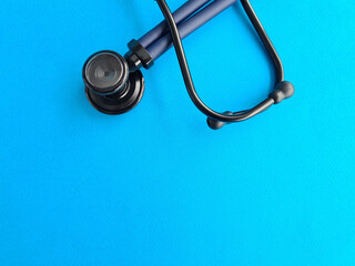 Medical stethoscope on blue background listening to lungs for inflammation