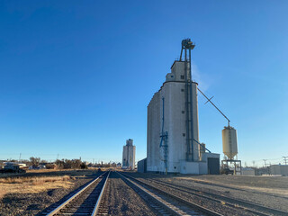 Fototapeta na wymiar railway in the countryside with grain elevator