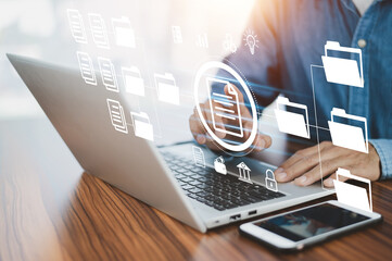 Document management concept, Businessman using  computer to document management concept, online documentation database and digital file storage system or software, records keeping, database technology