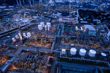 aerial view oil refinery Oil and gas industry, petrochemical plant area and energy concept, oil storage tanks at night time with lights.